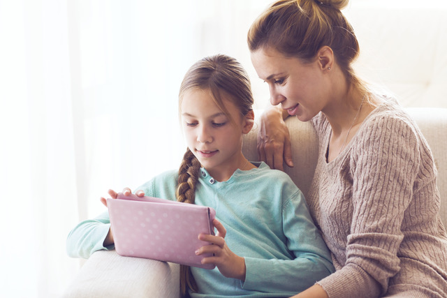 woman sitting with a child on a couch